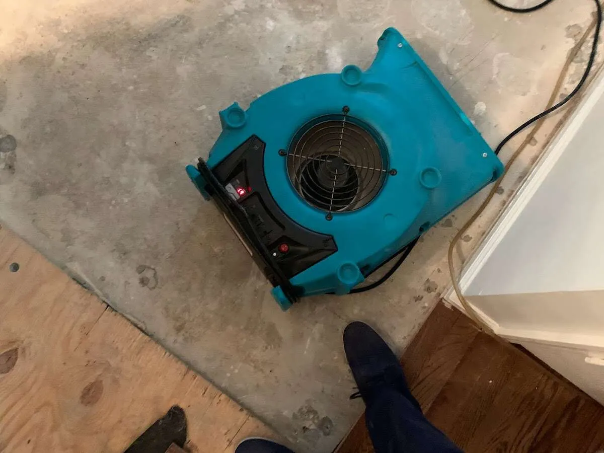 Air mover drying subfloor during Commercial Water Damage Restoration in Lehigh